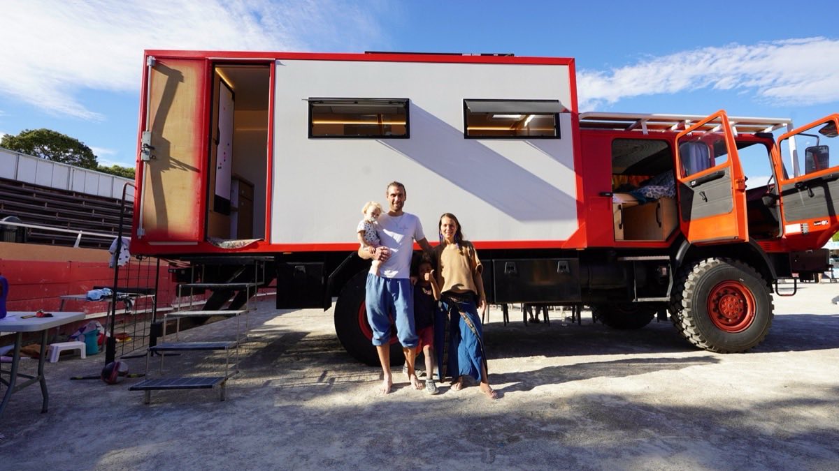 Une famille pose devant un camion aménagé en habitat léger